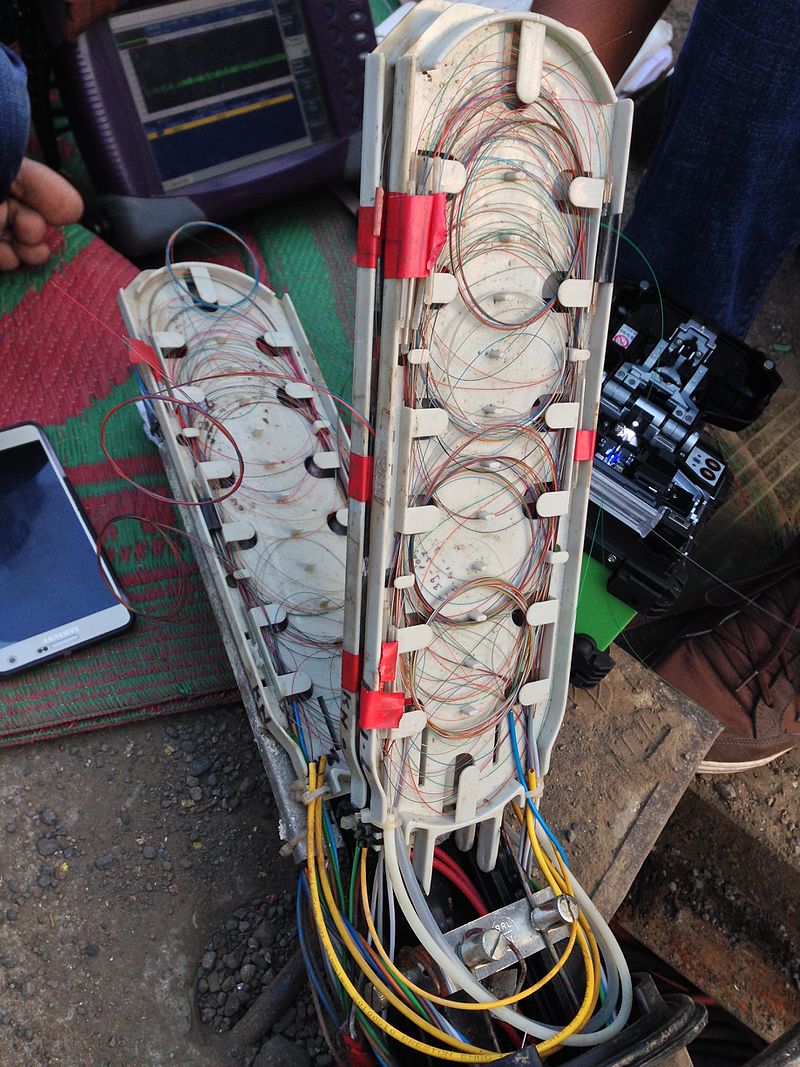 Technicians_investigating_a_fault_in_an_optical_fiber_cable_junction_box.jpg